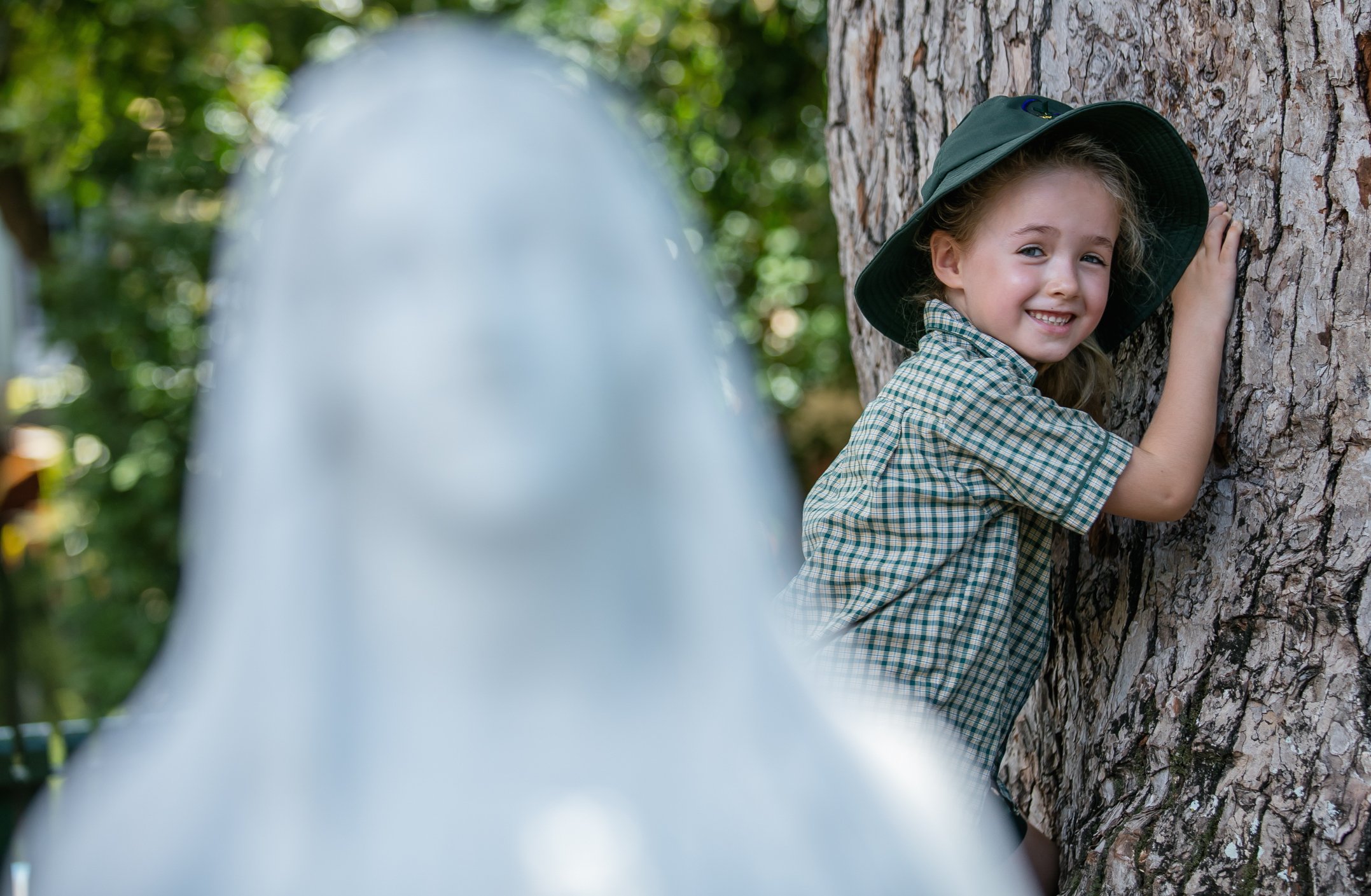 A girl standing with angel statue