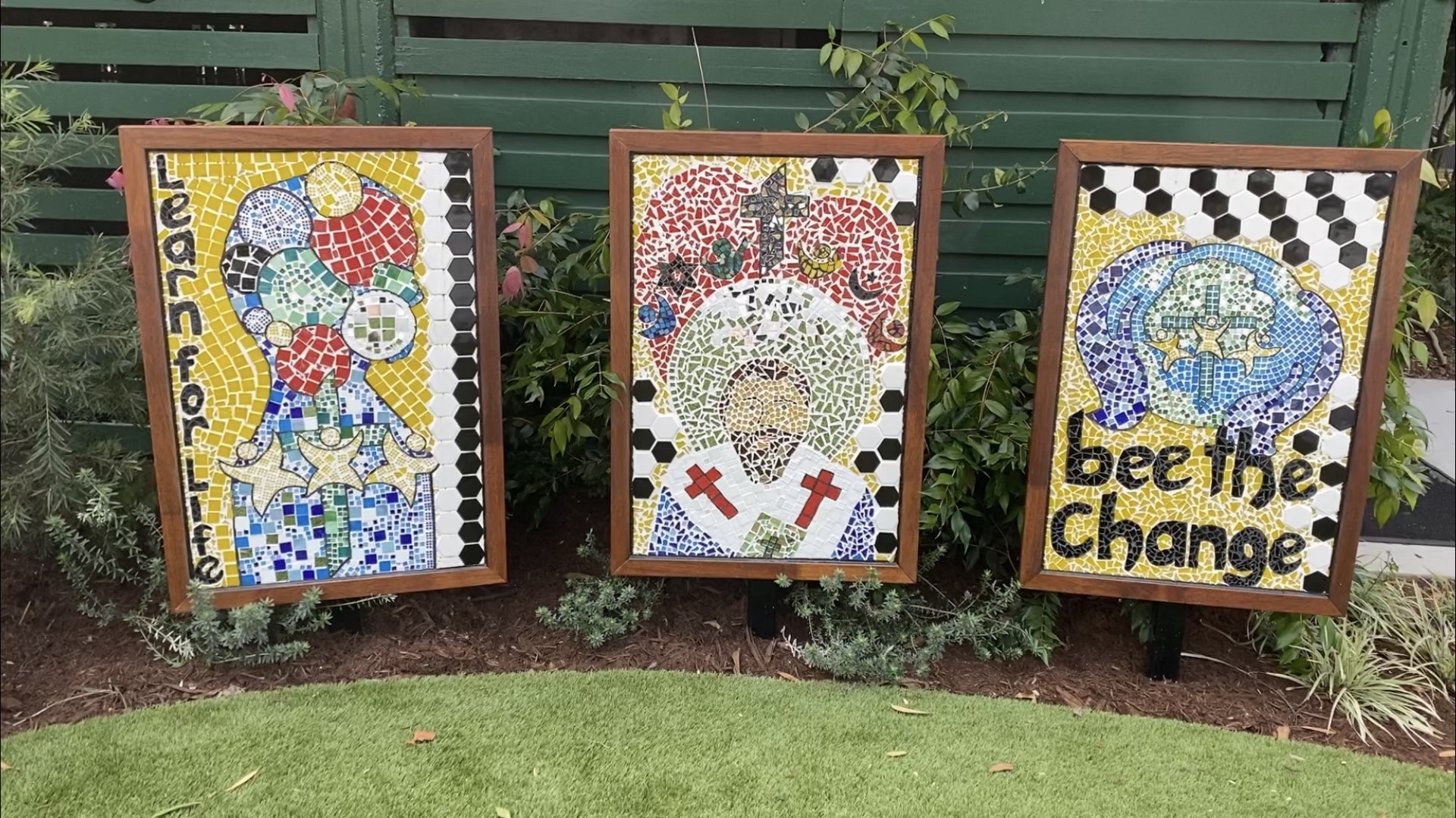 Student mosaic artworks displayed in the school garden, reflecting creativity, reflection and values‑based learning at St Ambrose’s Primary School